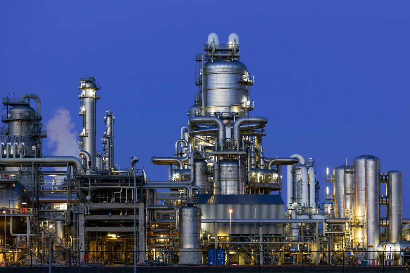 Industrial processing plant lit up at dusk