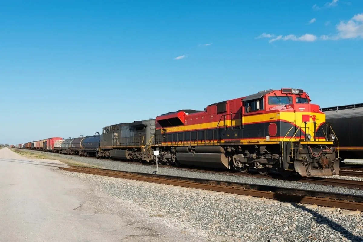 Diesel locomotive hauling a freight train alongside the track