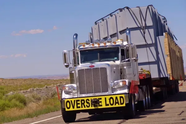 Heavy-haulage prime mover with an oversize load on an open highway